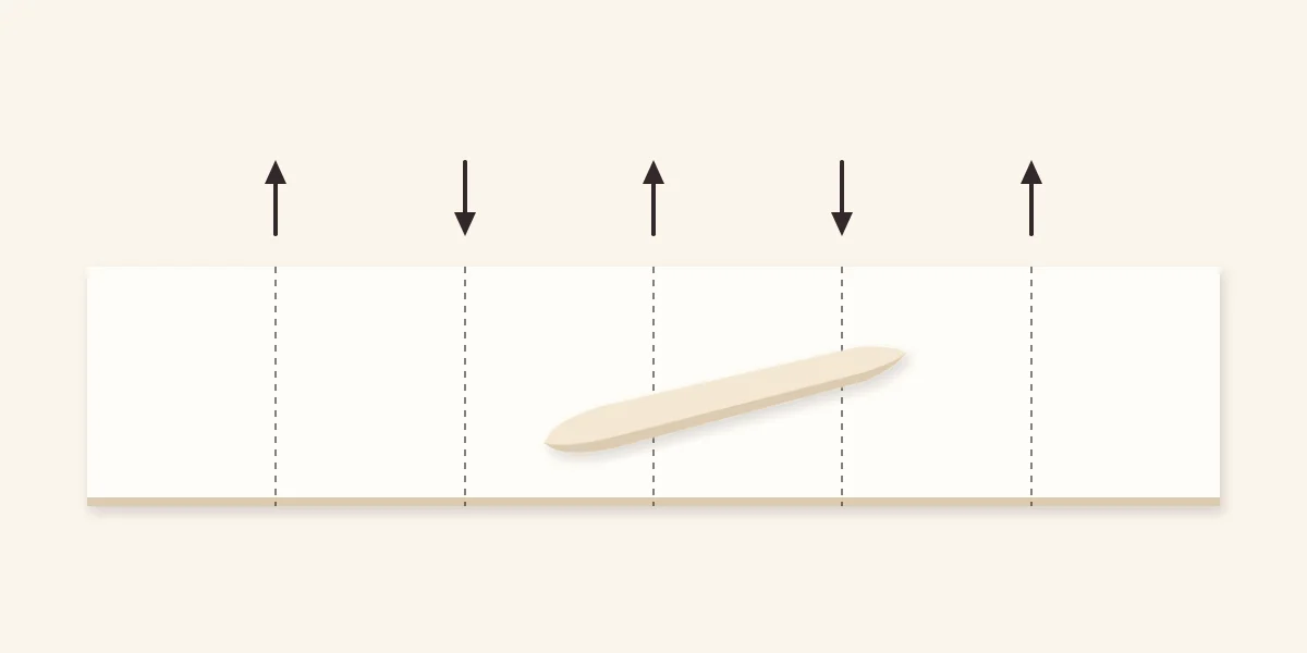 Long paper strip divided into six equal panels with alternating fold directions