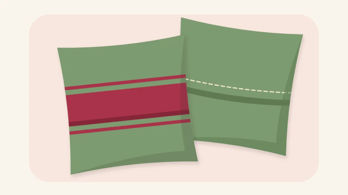 Two square pillows, one showing the front and one showing the overlapping envelope back