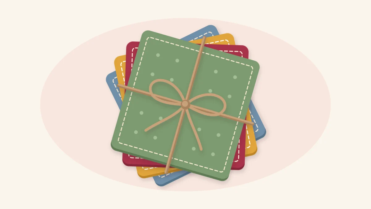Four square fabric coasters with topstitched edges stacked and tied with twine