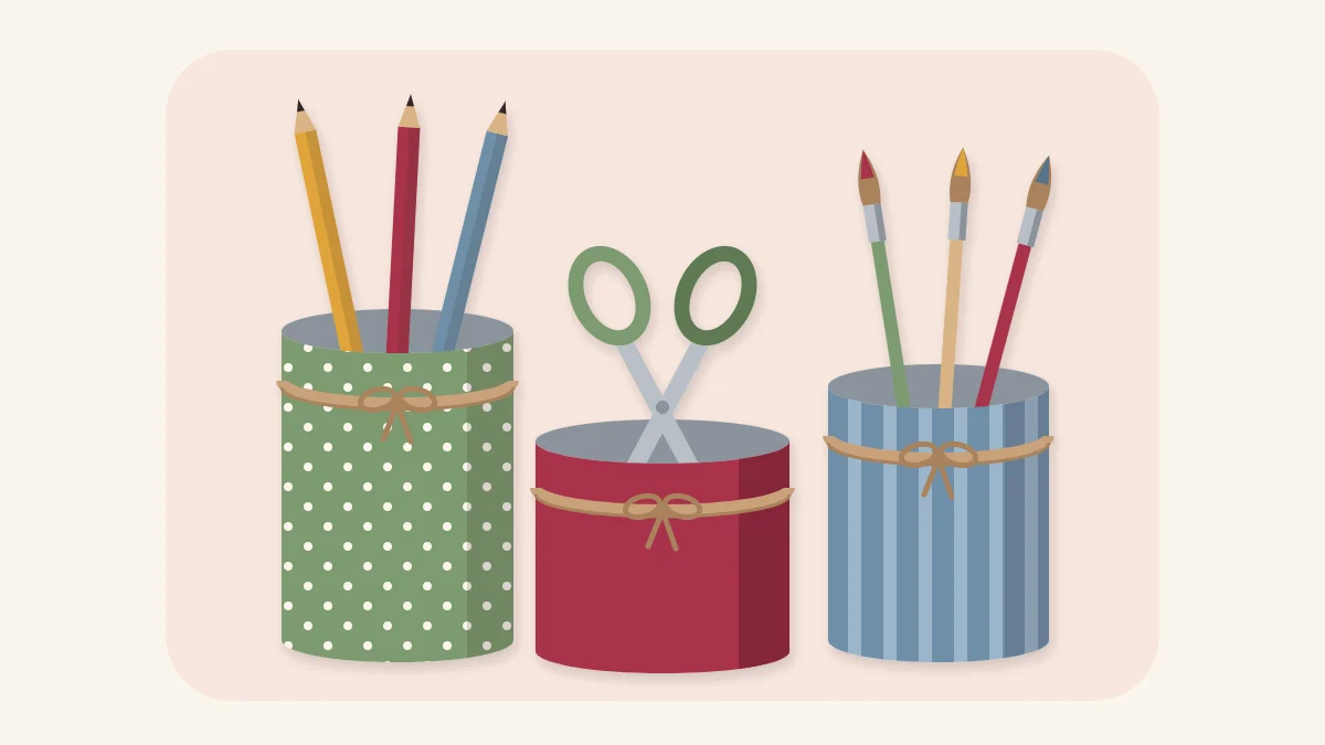 Three fabric-covered cans of different heights holding pencils, scissors and brushes